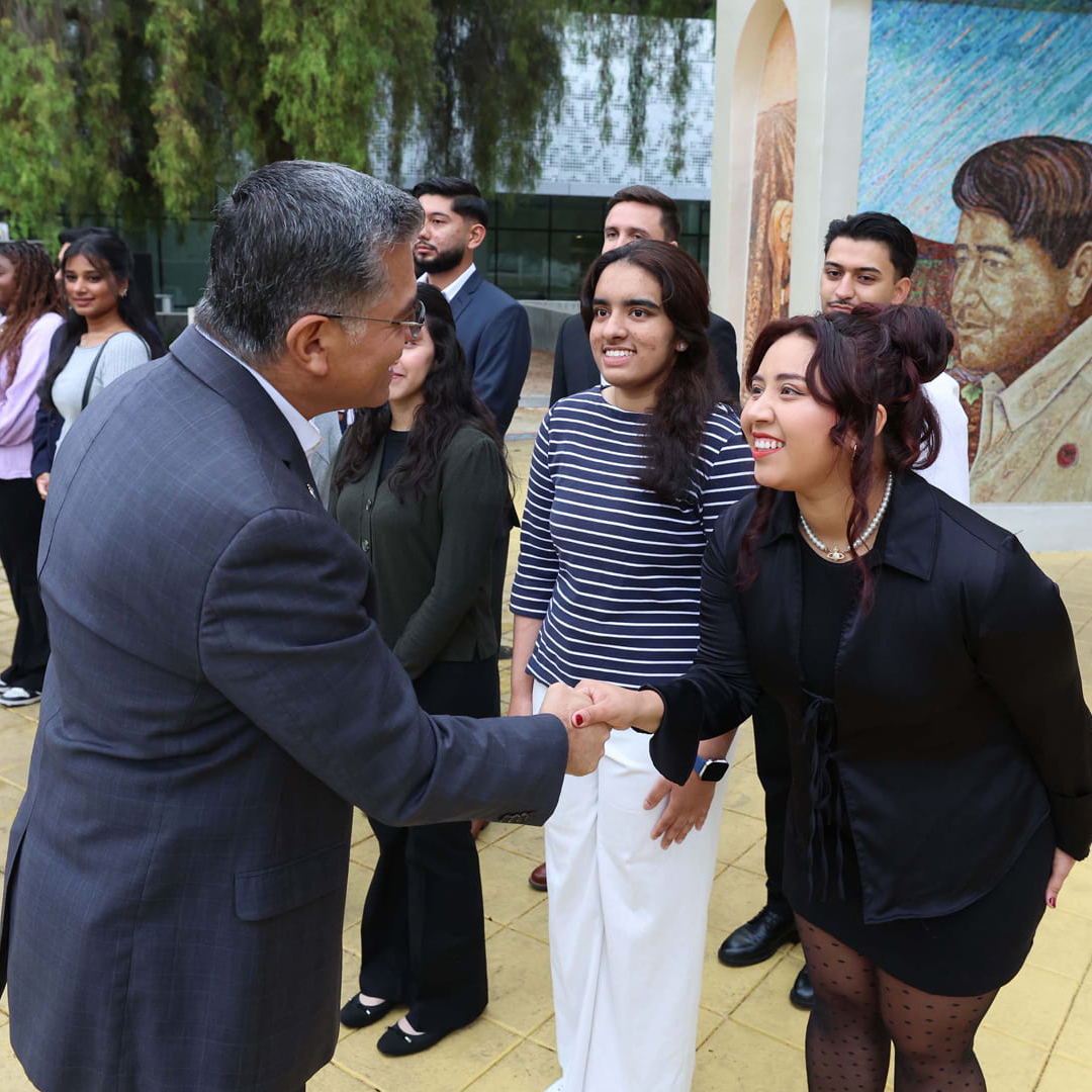 U.S. Secretary of Health and Human Services (HHS) Xavier Becerra shakes hands with Katy Reyes, ‘26 Aviation, during a recent visit to SJSU. Photo by David G. McIntyre.