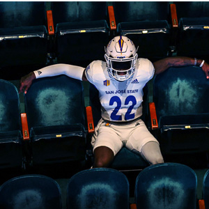 A SJSU football player sits in the Hammer Theatre venue.