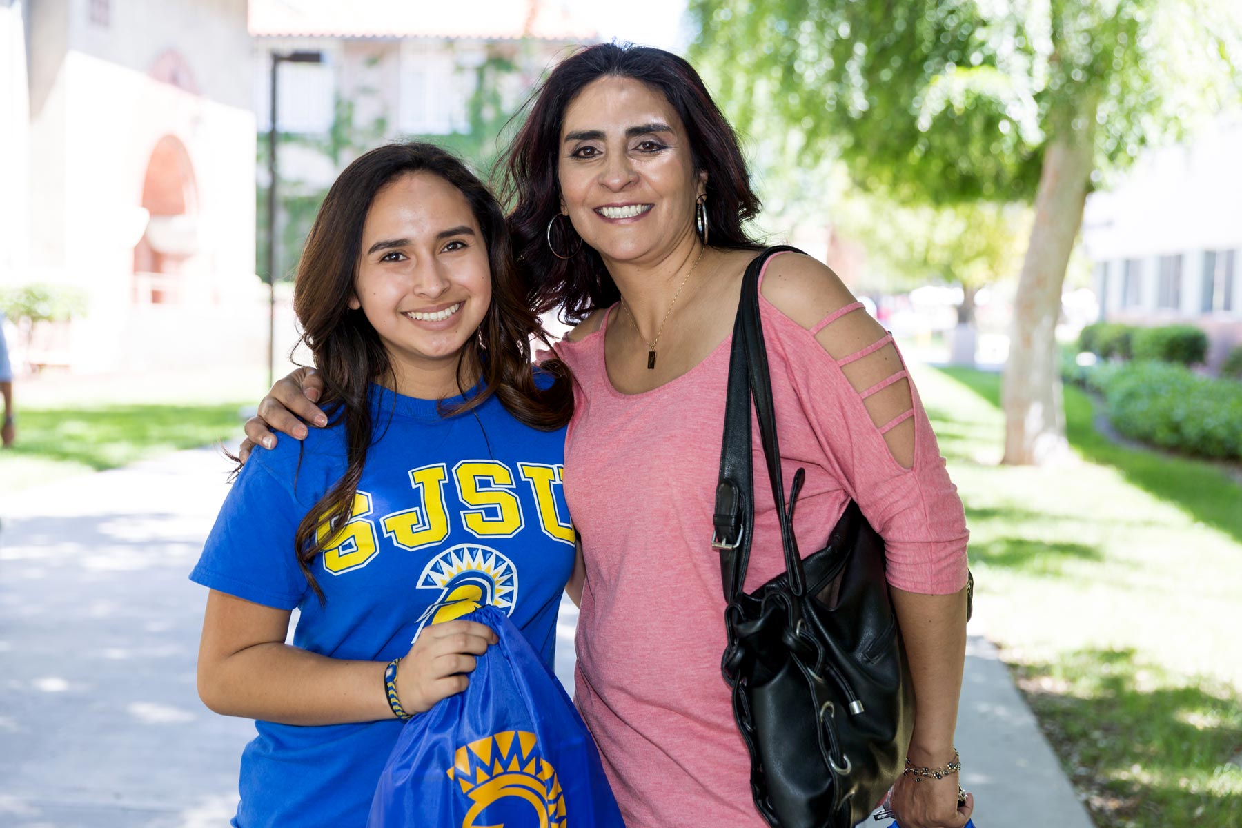 A student and a parent pose for a photo on Admitted Spartan Day.