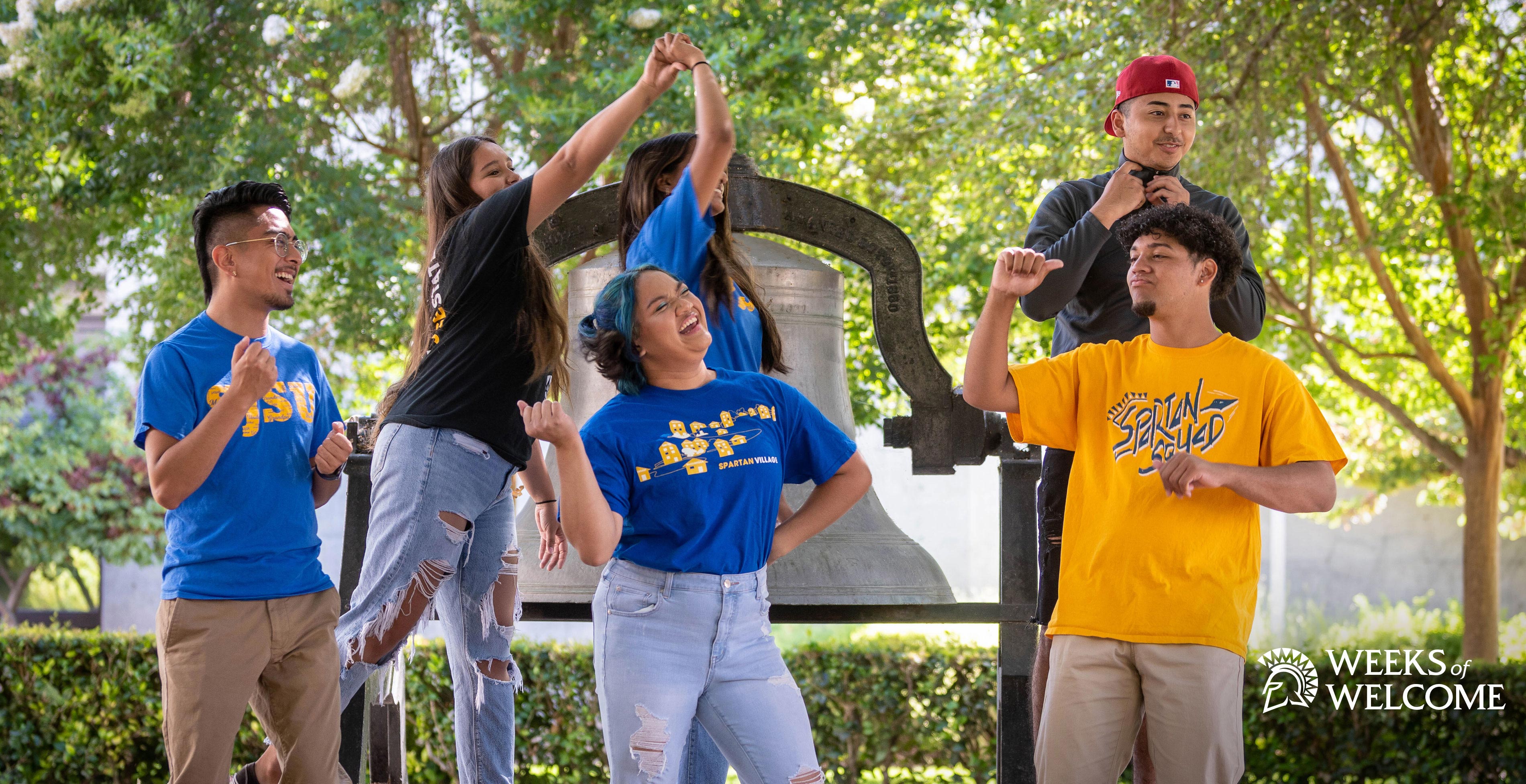 SJSU Students dancing and goofing around in front of the Tower Bell.