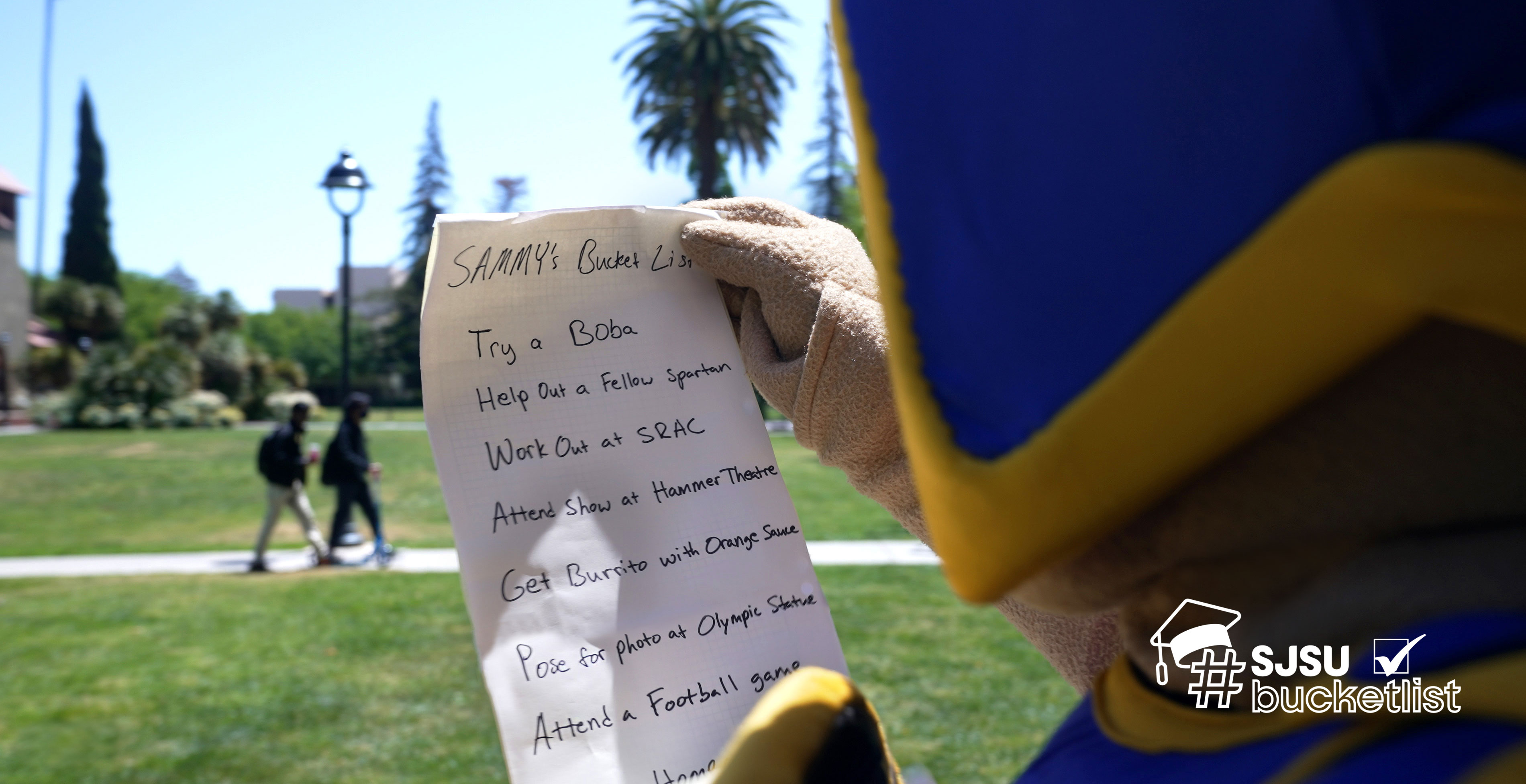 Sammy Spartan glances at his bucket list scroll while on campus.