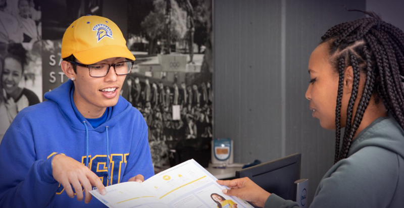 Student showing a newly admitted Spartan a map of campus