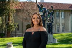 Black female in black blouse in front of Victory statue at SJSU