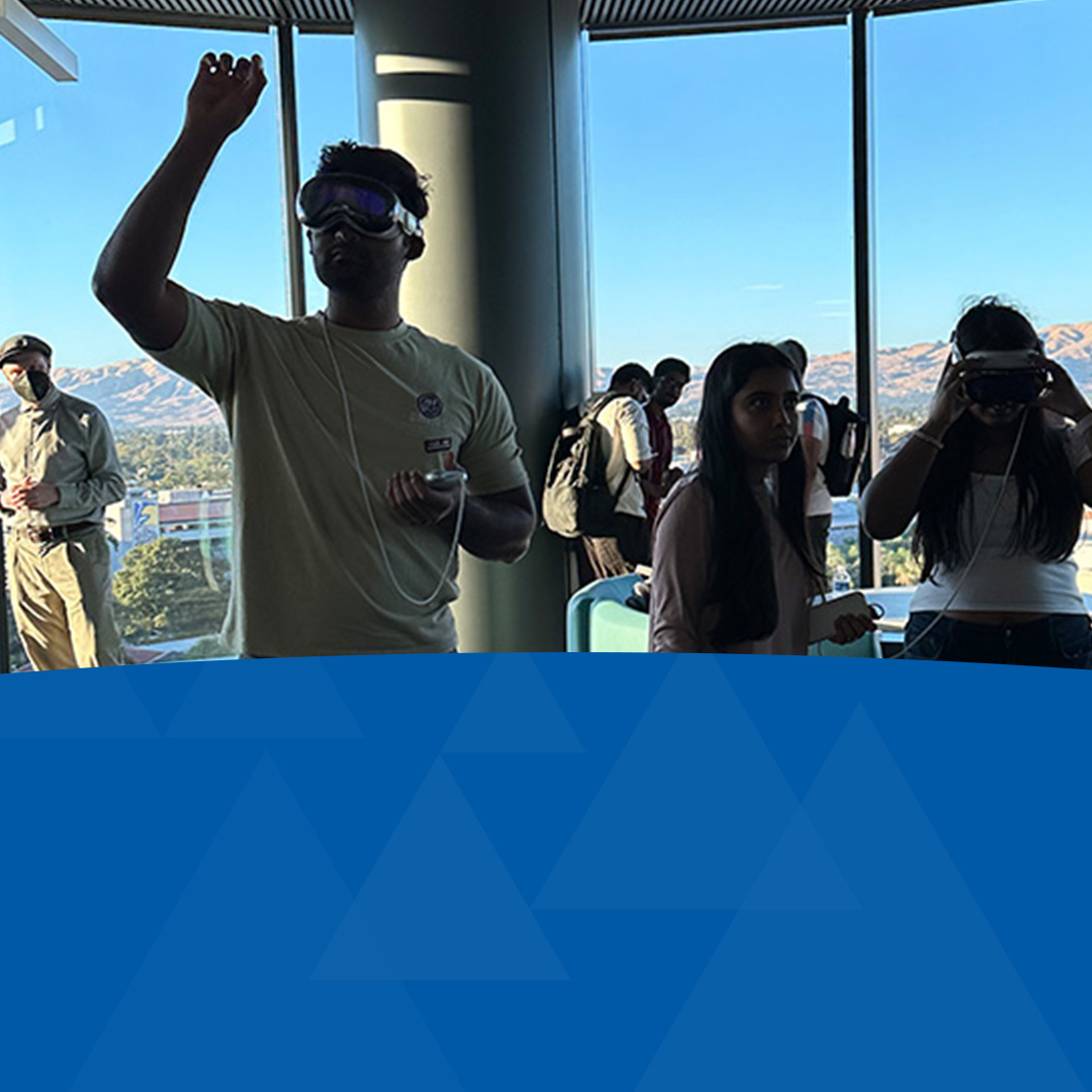 Department students exploring with a VR headset at a event