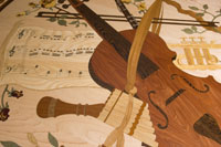 Close-up view of the wood floor medallion featuring a violin