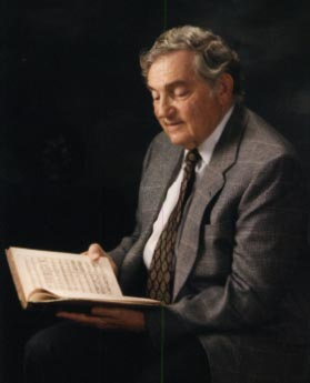 Portrait of Ira F. Brilliant holding a book