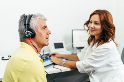 A clinician conducts a hearing screening