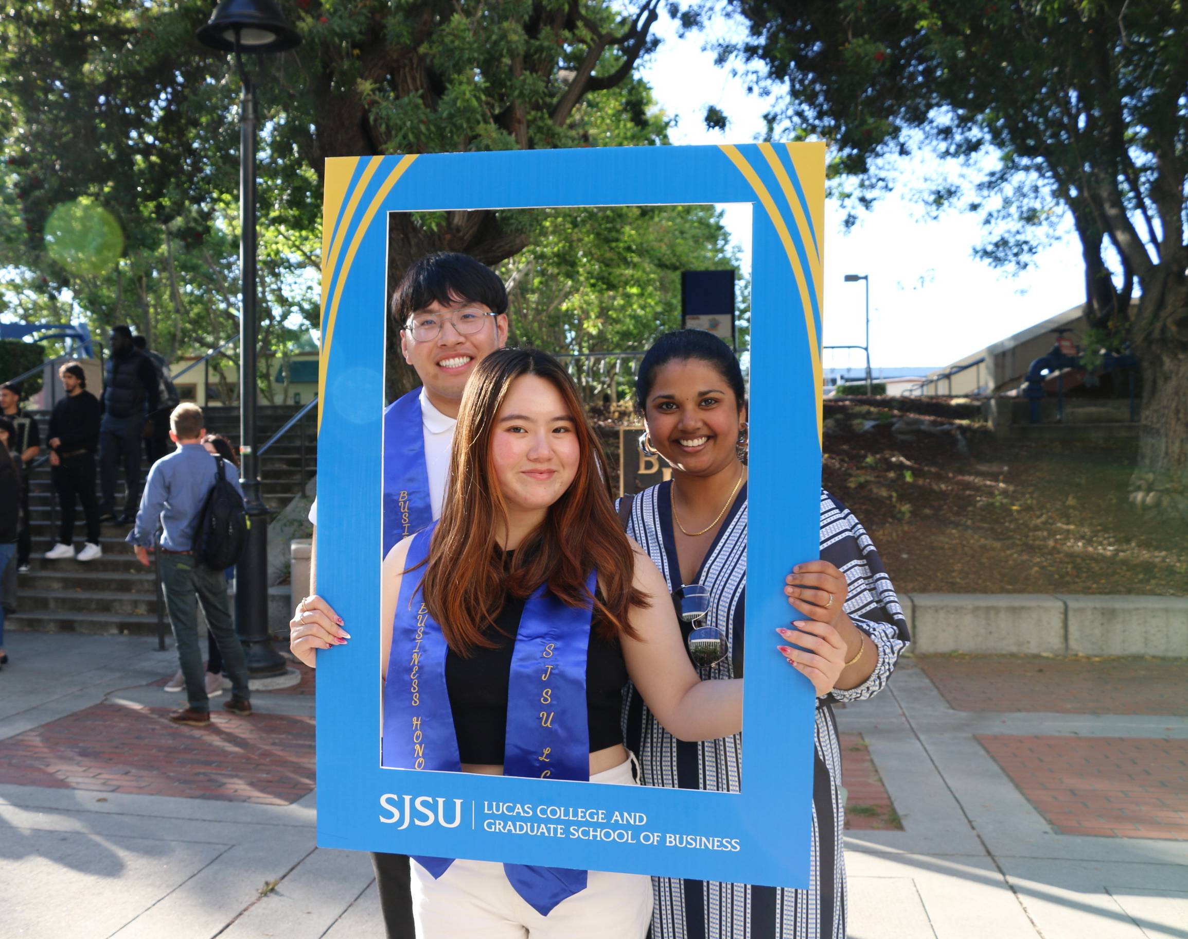 Students pose with a blue and gold LCoB frame