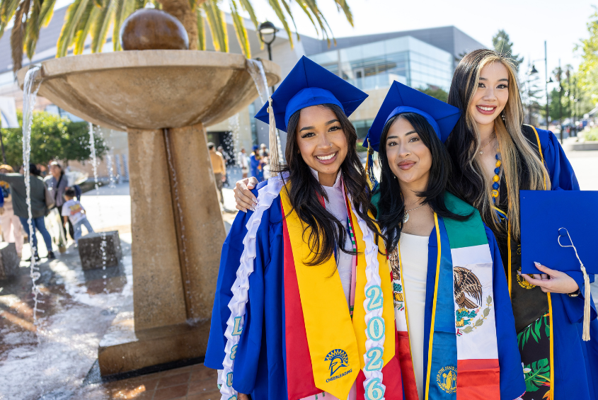 Students posing in front of a fountain