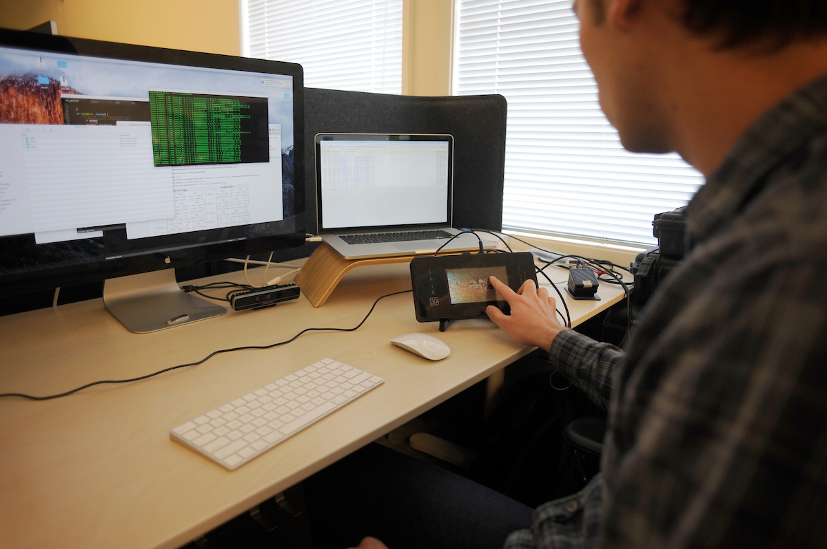 student with a laptop and machine