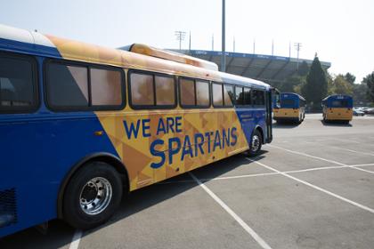 SJSU bus with a blue and gold wrap.