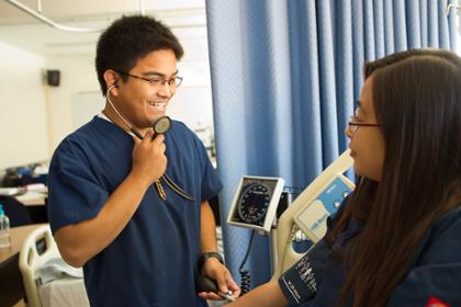 Nursing student takes another student's blood pressure