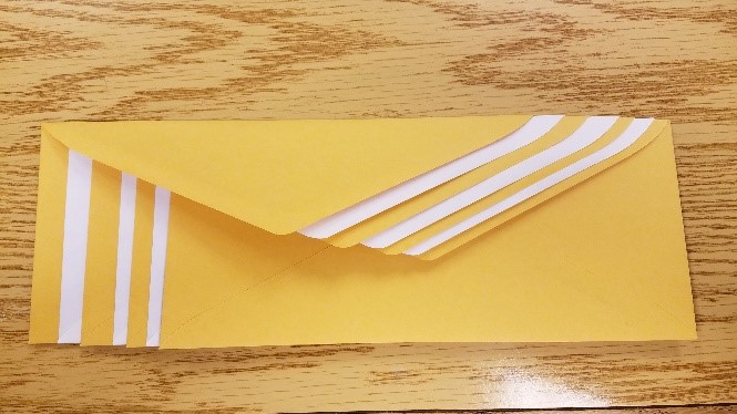 Envelopes interleaved so flaps are stacked on top of each other