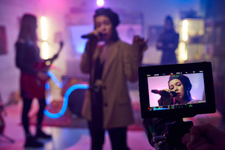 Stock image of a lead singer of a band performing on the set of a music video