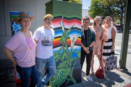 people involved in painting utility boxes