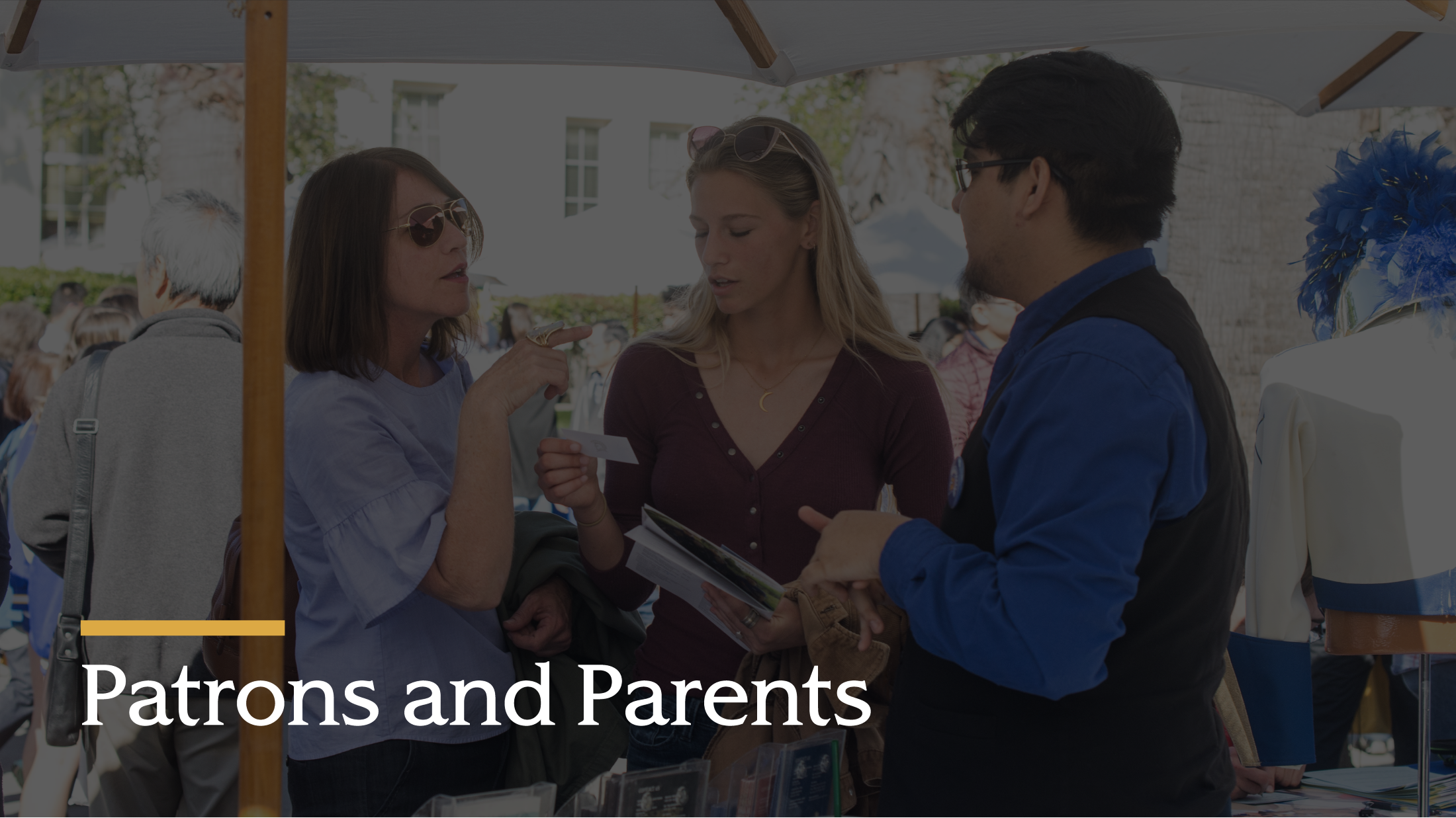 Group of three patrons and parents talking.