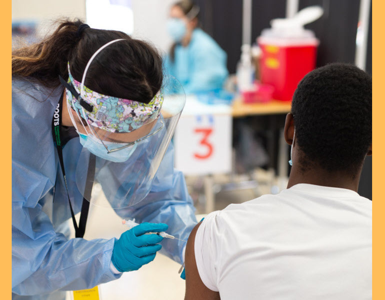 A BSN student, Bree Casas, administers a COVID-19 vaccination in 2022.