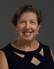 Portrait of Ruth Rosenblum, on a dark grey background