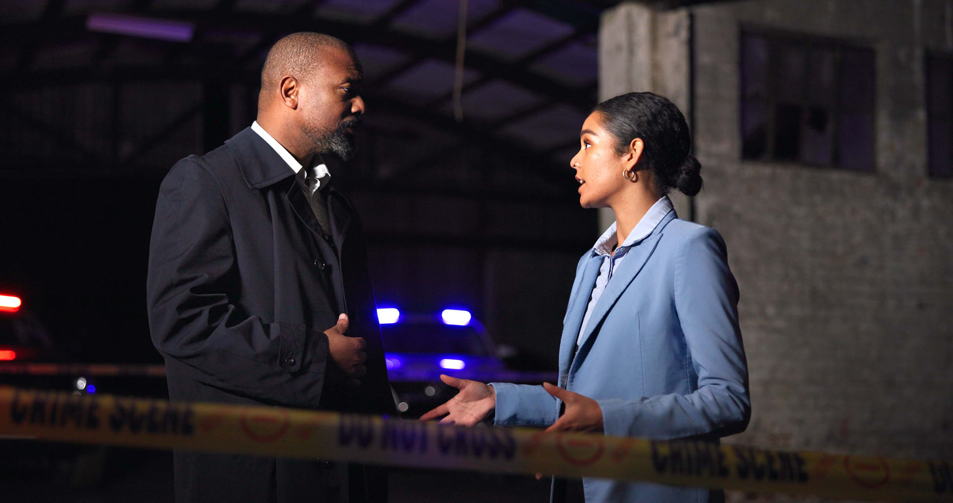 Two detectives discussing at a crime scene