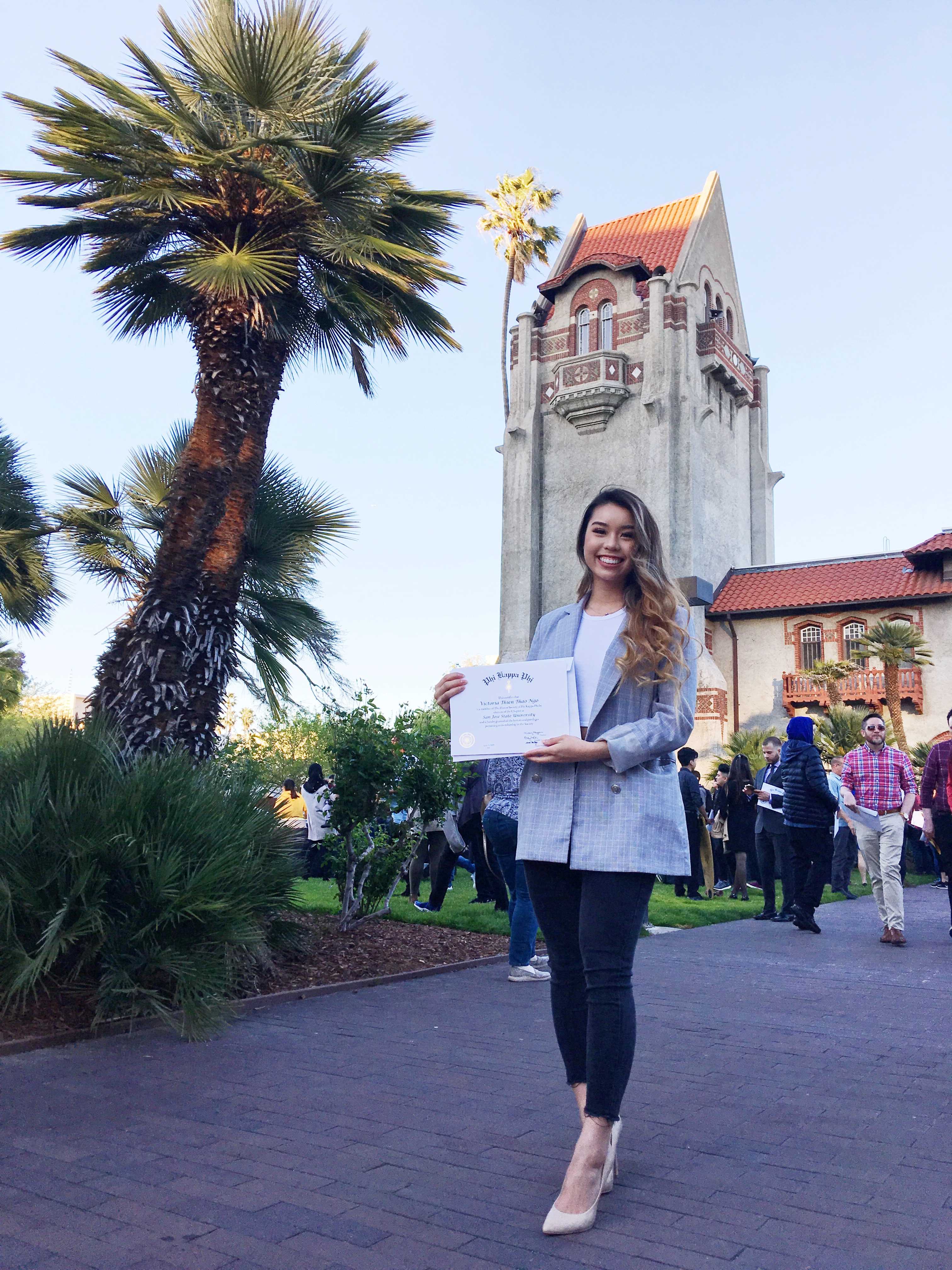 A public health student standing in front of the SJSU Tower
