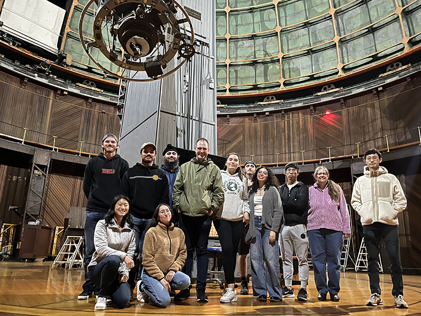 Group photo of SJSU students inside the 36-inch great refracting telescope dome.