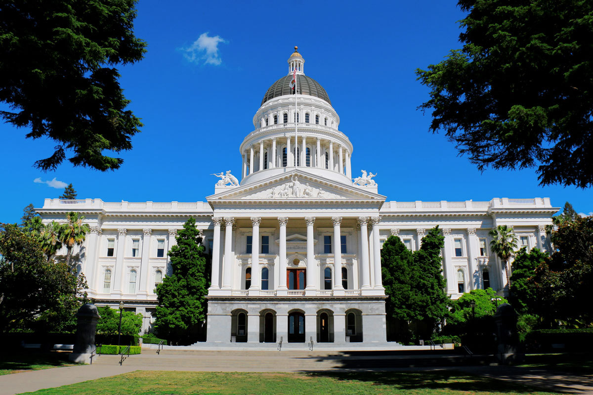 Front side of the State Capitol Building in Sacramento on a blue sunny day.