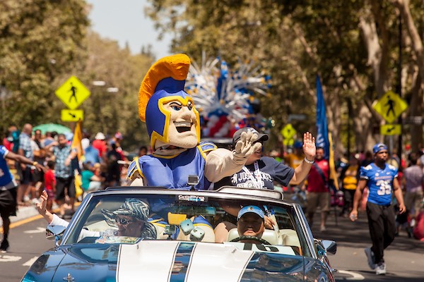 Sammy Spartan driving through a parade.