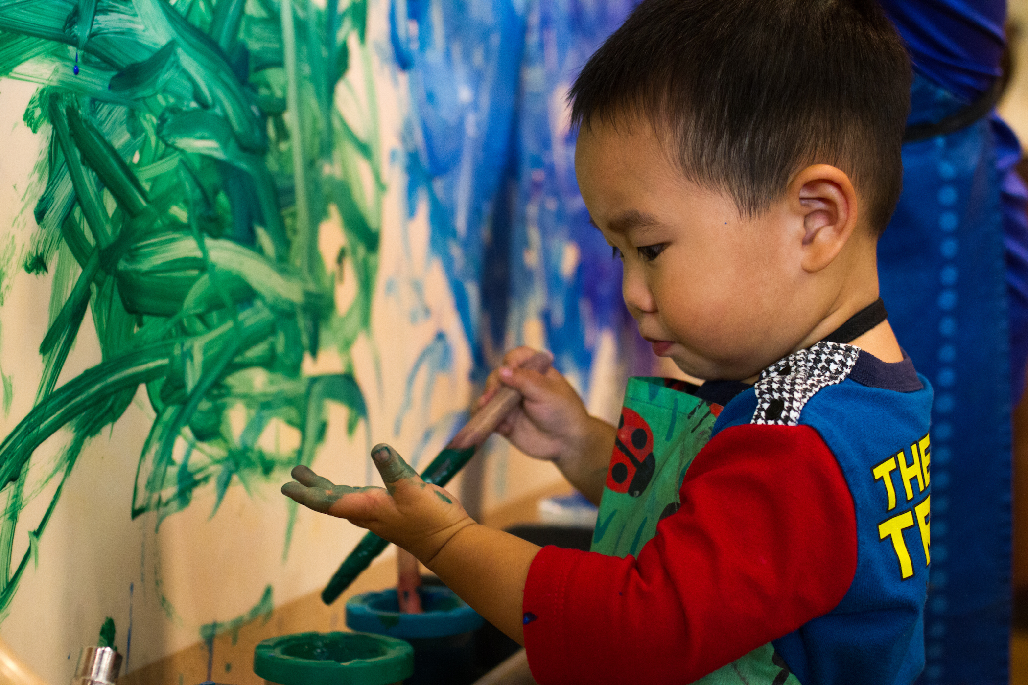 Little boy painting.