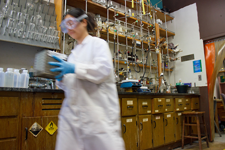 person in motion walks through lab with lab gear on
