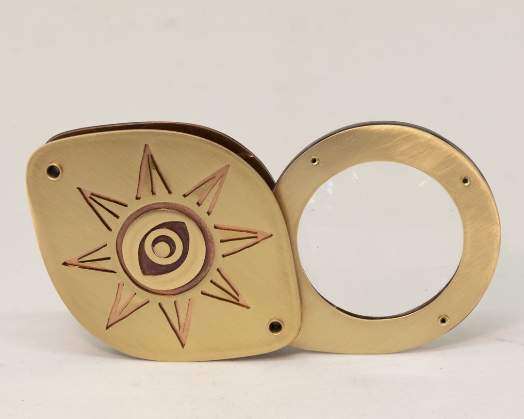 close of brass ring with sun pattern