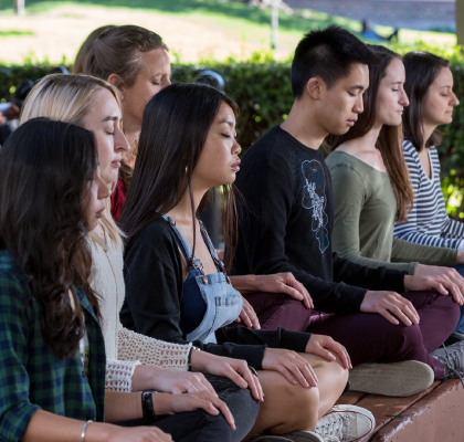 Group of students doing meditation
