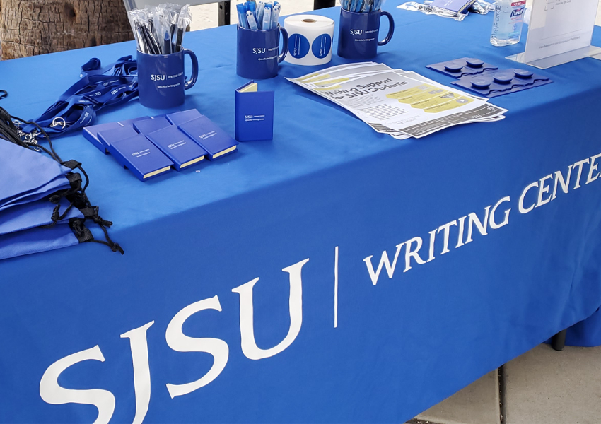 Table displaying various Writing Center items such as mugs pens