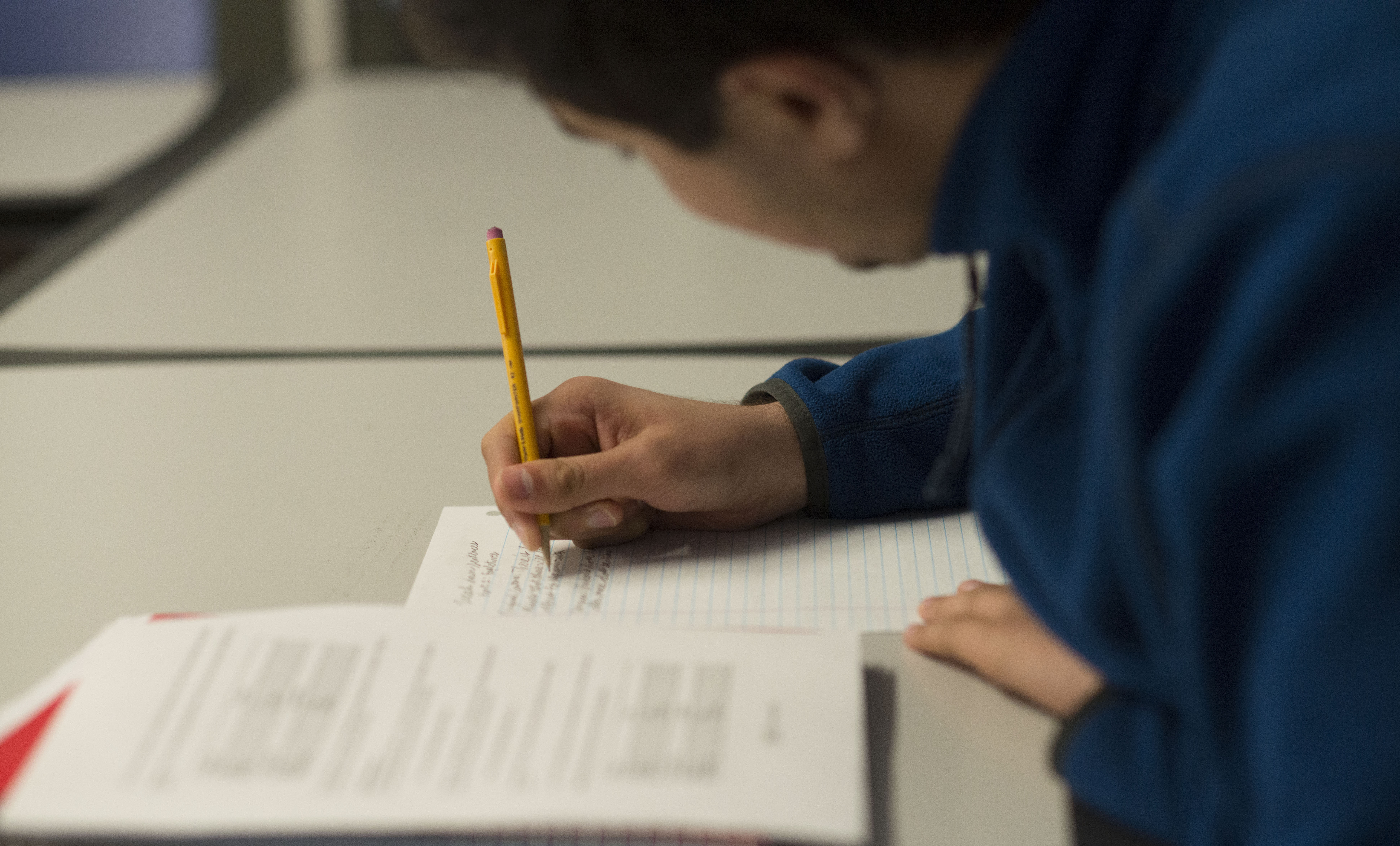Main page picture of a student writing a paper. 